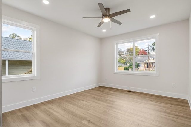 unfurnished room with ceiling fan, plenty of natural light, and light hardwood / wood-style floors