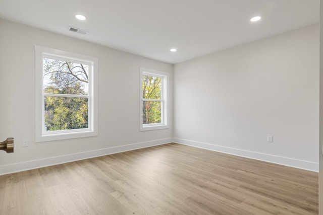 unfurnished room with light hardwood / wood-style floors