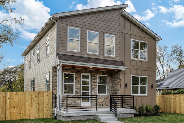 view of front of house featuring a front yard and covered porch