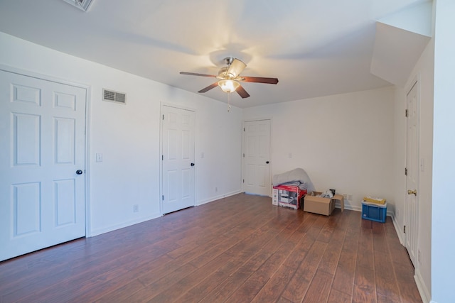 interior space featuring ceiling fan and dark wood-type flooring