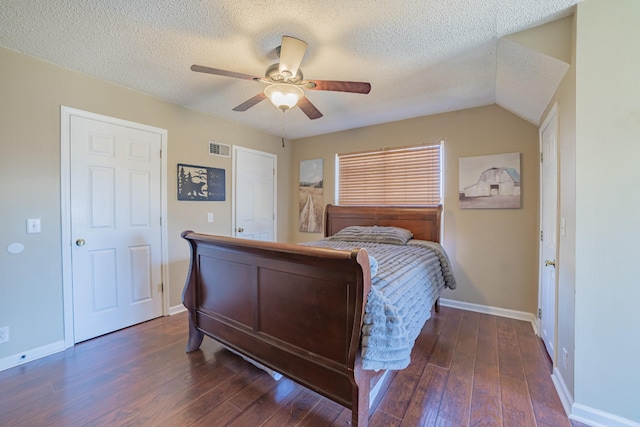 bedroom featuring ceiling fan, dark hardwood / wood-style flooring, and a textured ceiling