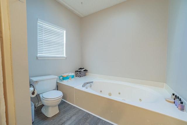 bathroom with wood-type flooring, a bath, and toilet