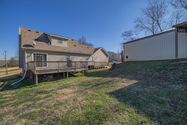 rear view of property featuring a wooden deck and a yard