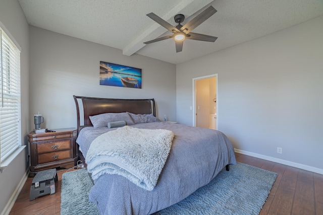 bedroom featuring ensuite bath, a textured ceiling, ceiling fan, dark wood-type flooring, and beamed ceiling