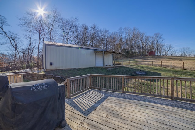 deck with a rural view, area for grilling, an outdoor structure, and a lawn