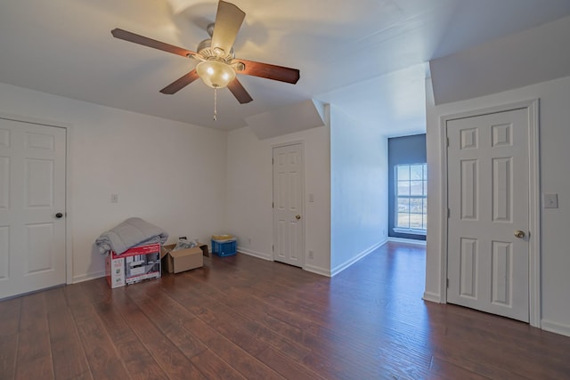 interior space with ceiling fan and dark wood-type flooring