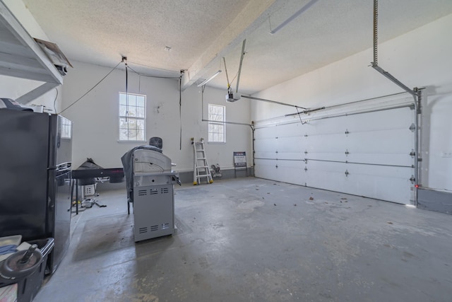 garage featuring black fridge and a garage door opener