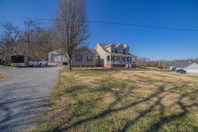 cape cod home featuring a porch, a garage, and a front lawn