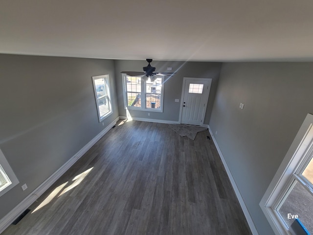 entrance foyer with baseboards, ceiling fan, and dark wood-style flooring