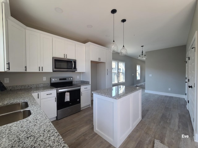 kitchen with white cabinets, dark wood-style floors, and stainless steel appliances