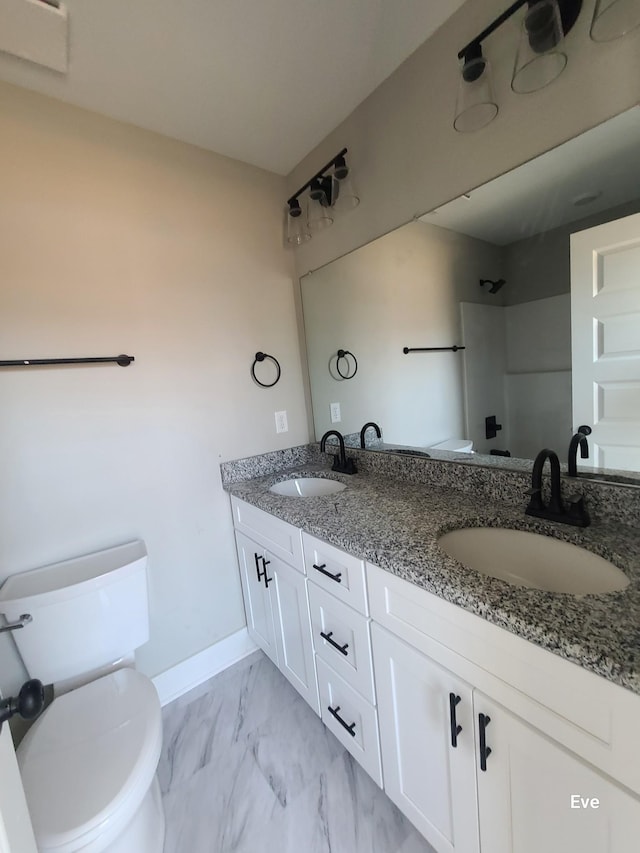 full bathroom featuring a sink, baseboards, toilet, and marble finish floor