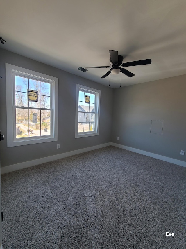 spare room with carpet flooring, a ceiling fan, and baseboards