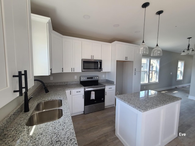 kitchen featuring a sink, a center island, stainless steel appliances, white cabinetry, and dark wood-style flooring