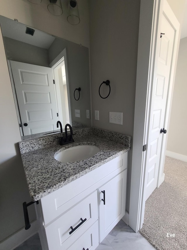 bathroom featuring vanity and baseboards