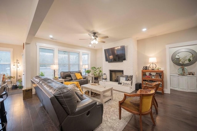 living area with baseboards, ceiling fan, recessed lighting, a fireplace, and dark wood-style floors