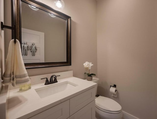 bathroom with toilet and vanity