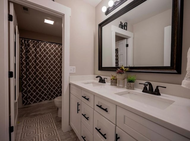 bathroom with a shower with shower curtain, double vanity, toilet, and a sink