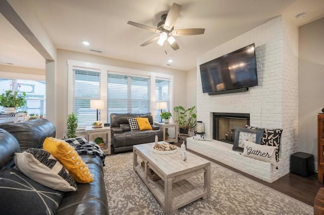 living area featuring recessed lighting, a fireplace, ceiling fan, and wood finished floors