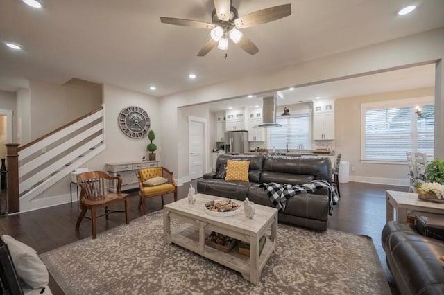 living area with a ceiling fan, dark wood-style floors, recessed lighting, stairway, and baseboards