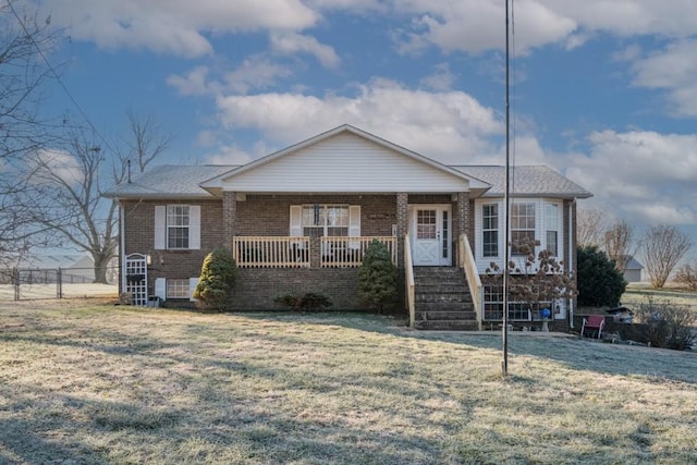 view of front of property with covered porch and a front yard