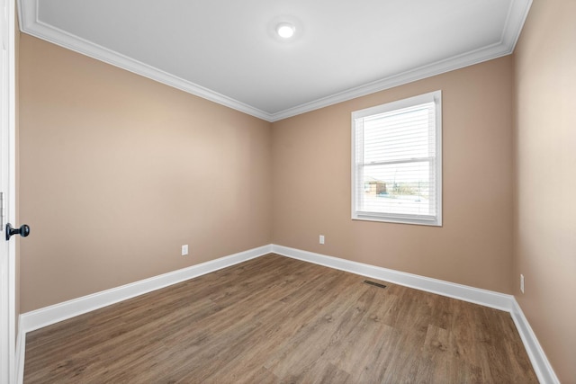 spare room with hardwood / wood-style floors and ornamental molding