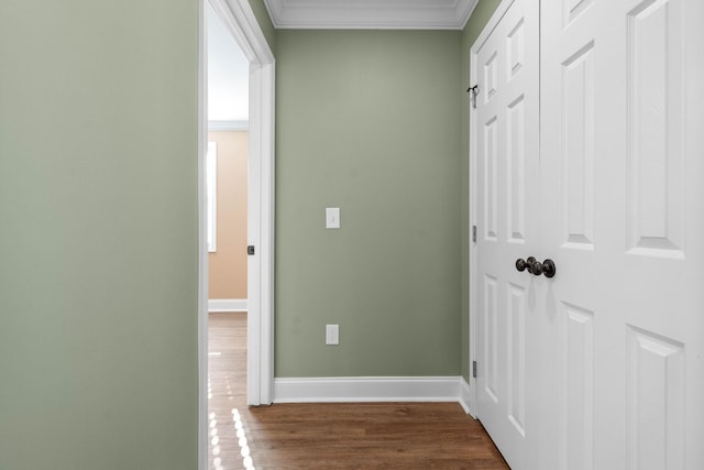 corridor with ornamental molding and dark hardwood / wood-style floors