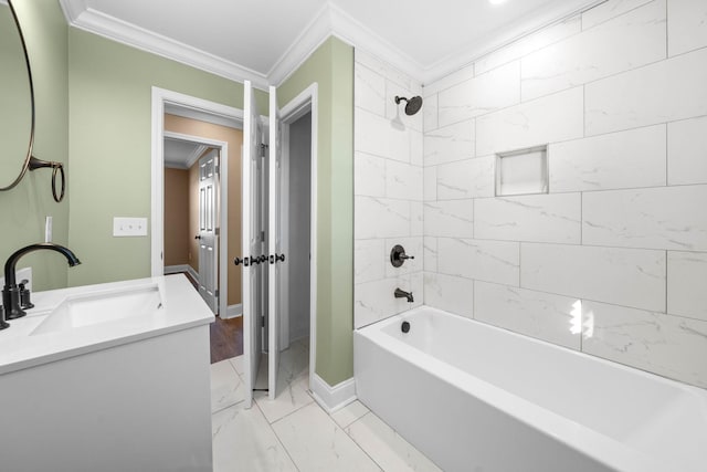 bathroom with vanity, ornamental molding, and tiled shower / bath