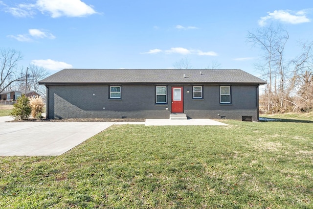 back of house with a lawn and a patio area