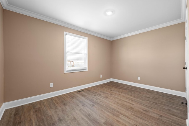 empty room with hardwood / wood-style floors and ornamental molding