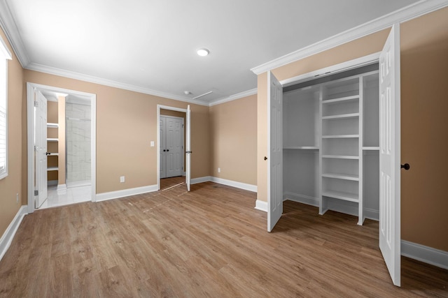 unfurnished bedroom featuring light wood-type flooring, ornamental molding, and a closet