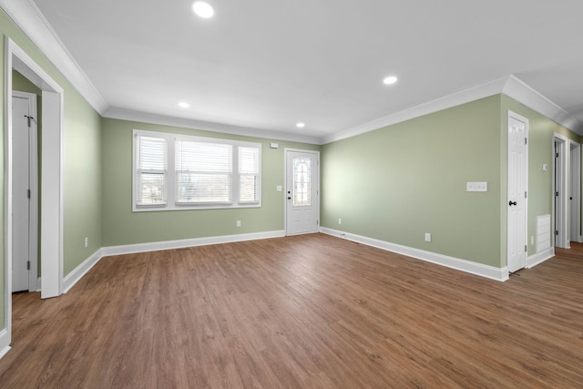 unfurnished living room with ornamental molding and wood-type flooring