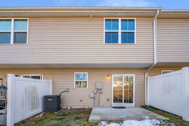 rear view of property with central AC and a patio area