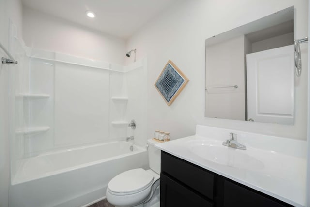 full bathroom featuring toilet, vanity, and washtub / shower combination