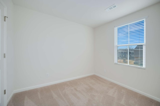 unfurnished room featuring light carpet