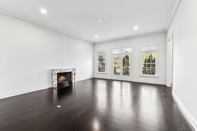 unfurnished living room featuring dark hardwood / wood-style floors, crown molding, and a premium fireplace