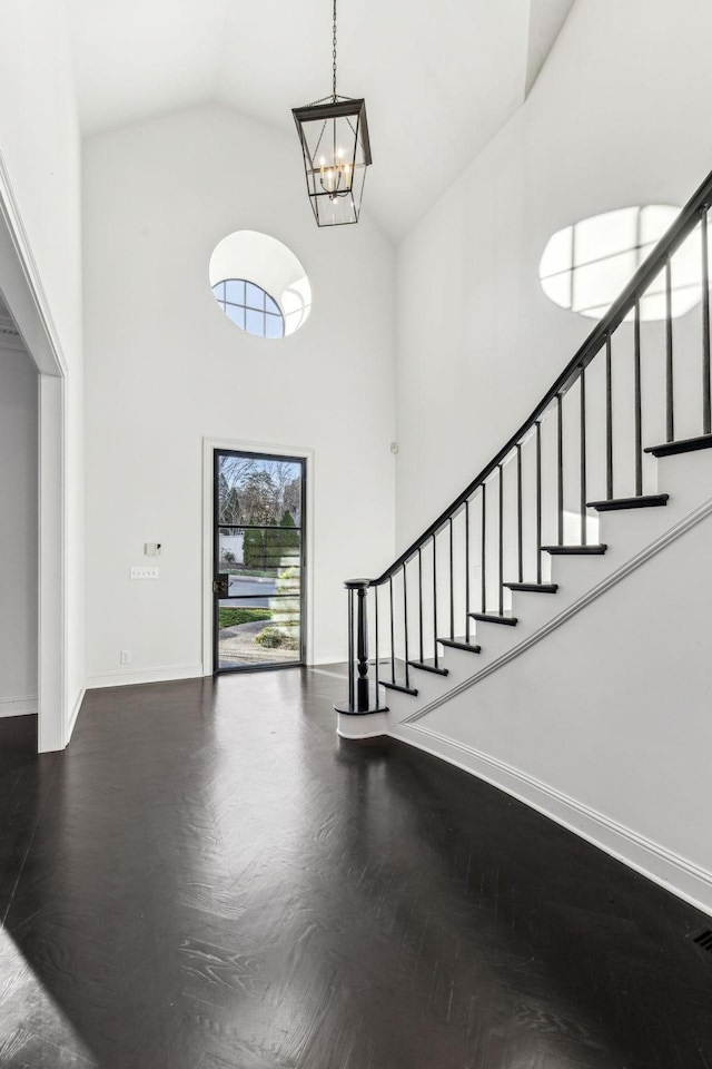 entrance foyer featuring a towering ceiling and an inviting chandelier