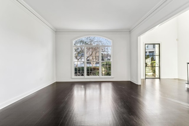 unfurnished room with dark wood-type flooring and ornamental molding