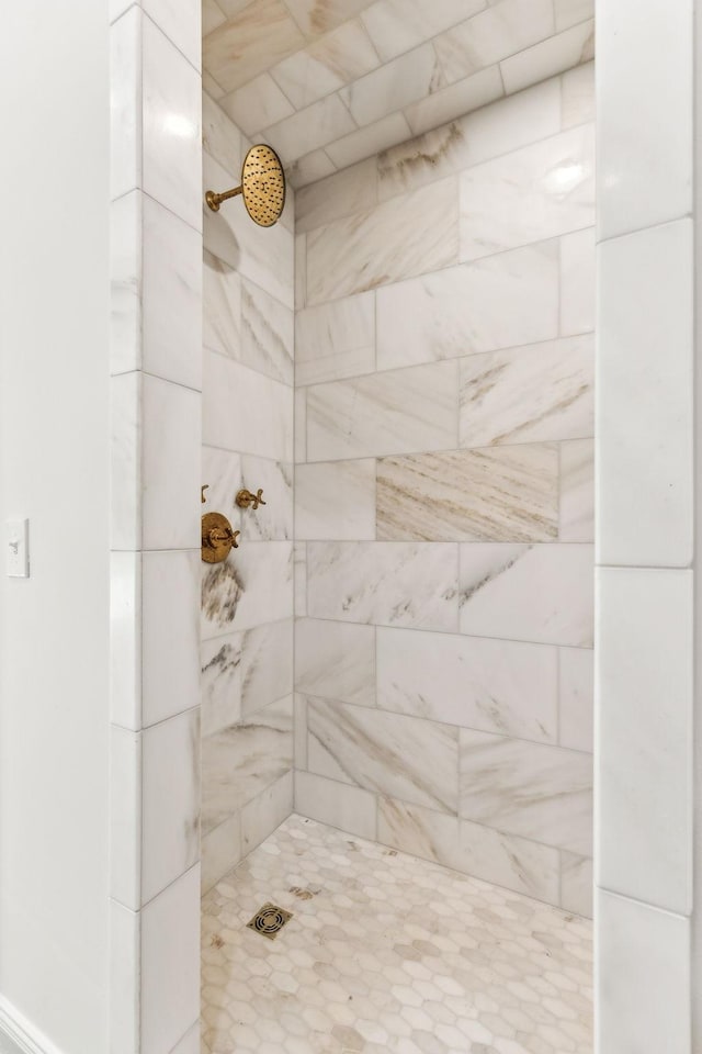 bathroom with a tile shower