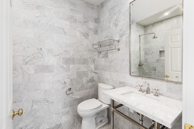 bathroom featuring toilet, a shower, and vanity