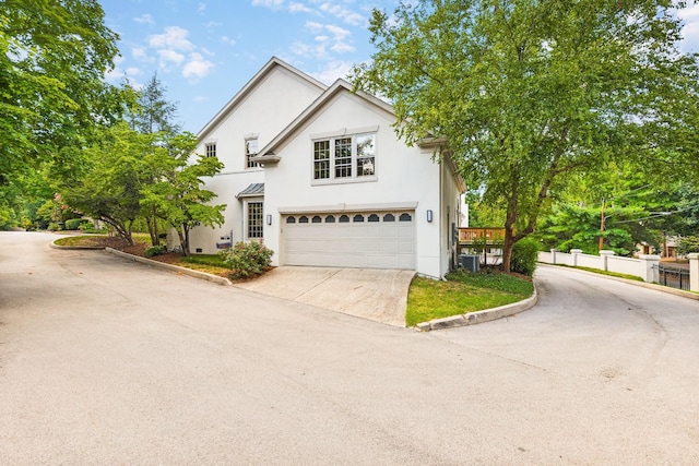 front of property featuring central AC and a garage