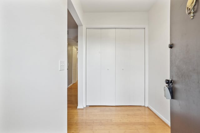 corridor with light wood-type flooring