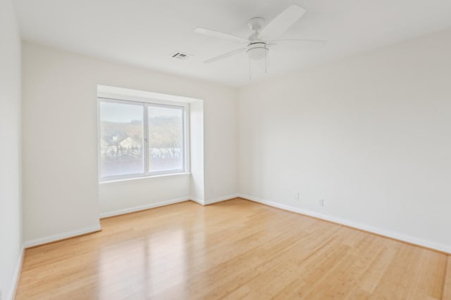 spare room with light wood-type flooring and ceiling fan