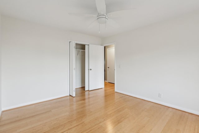 unfurnished bedroom featuring light wood-type flooring, ceiling fan, and a closet