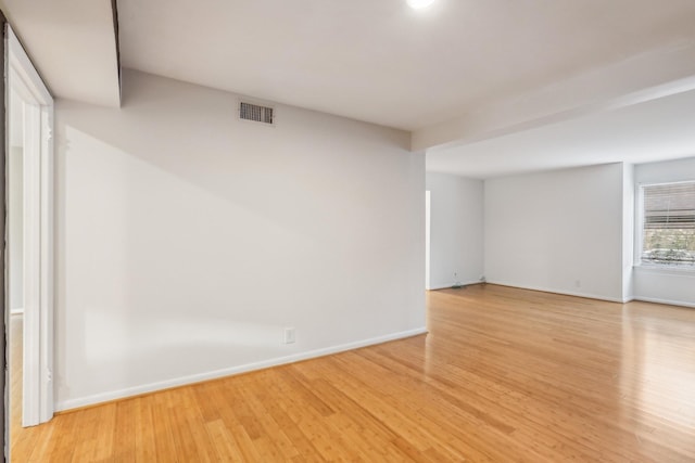 empty room with light hardwood / wood-style flooring