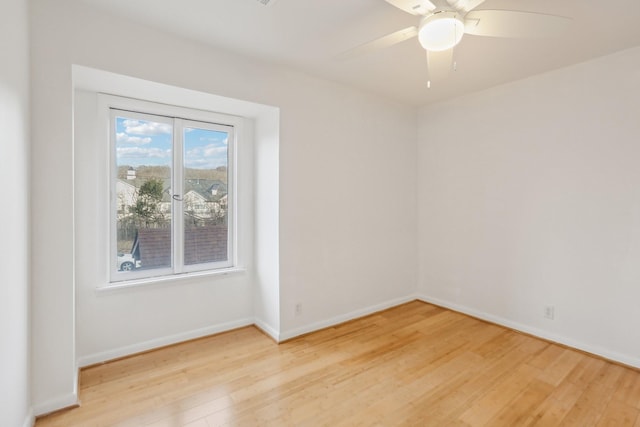 spare room with hardwood / wood-style flooring and ceiling fan