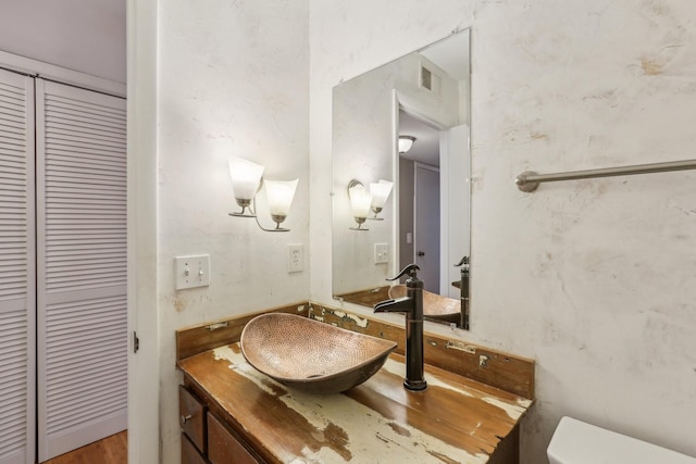 bathroom featuring toilet and vanity