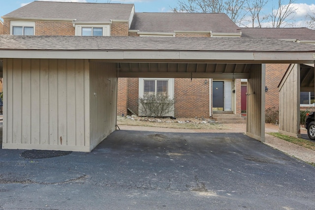 view of exterior entry with a carport