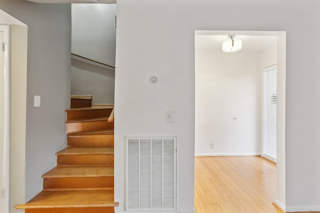 staircase featuring wood-type flooring