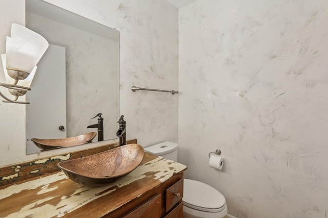 bathroom featuring toilet and vanity