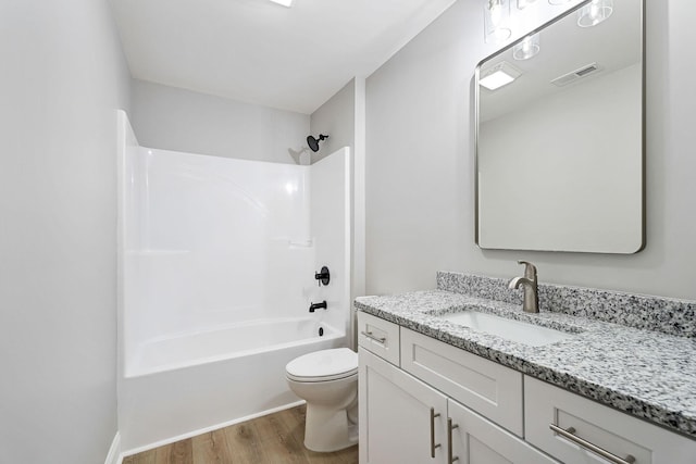 full bathroom featuring vanity, shower / bathing tub combination, wood-type flooring, and toilet